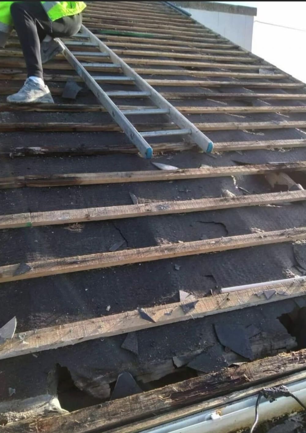 Old slates off and battens exposed, ready for re-covering
